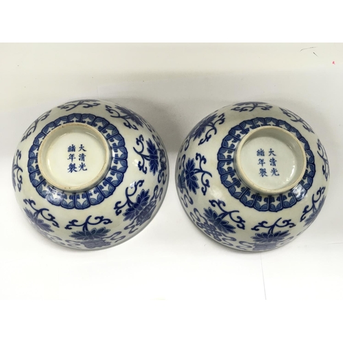 1193 - A pair of Chinese blue and white bowls raised on hardwood stands, approx diameter of bowls 16cm.