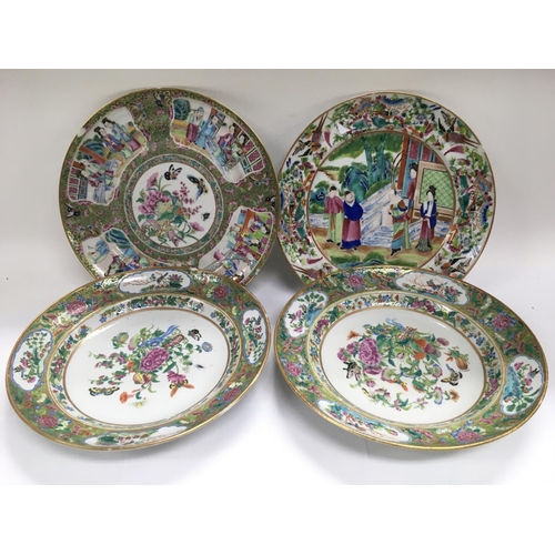 1197 - Four Canton plates comprising a pair with a centralised image of butterflies and flowers and two oth... 