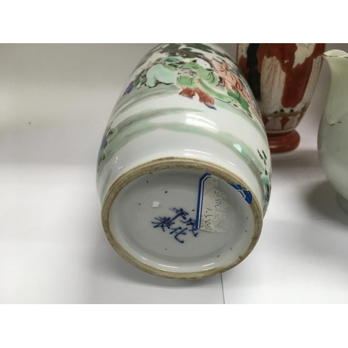 1201 - An Oriental vase depicting figures in a wooded landscape, a teapot decorated with herons etc. Some d... 