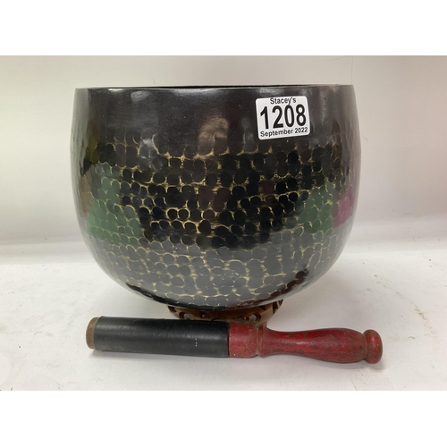 1208 - A large hammered Bronze singing bowl.