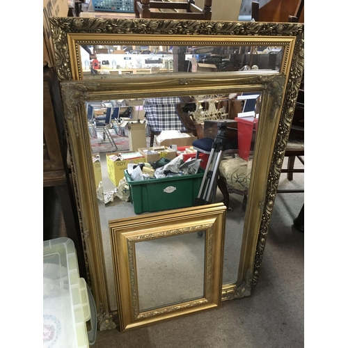 1315 - Three gilt framed wall mirrors, largest measuring approx 67cm x 97cm.