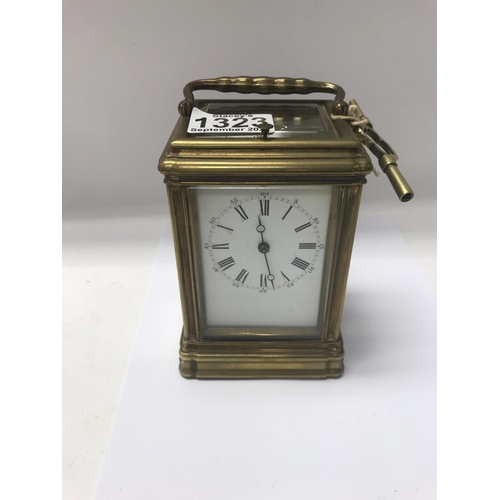 1323 - A brass cased carriage clock with repeat movement the dial with Roman numerals.