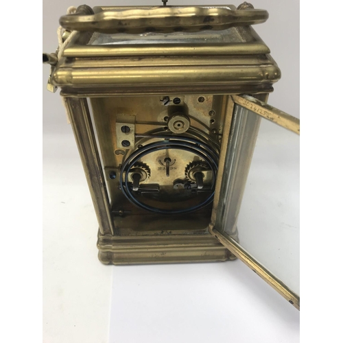 1323 - A brass cased carriage clock with repeat movement the dial with Roman numerals.