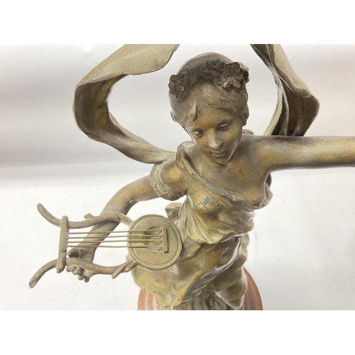 1330 - A large classical spelter figure of a maiden playing a harp mounted on a wooden base. 56cm.