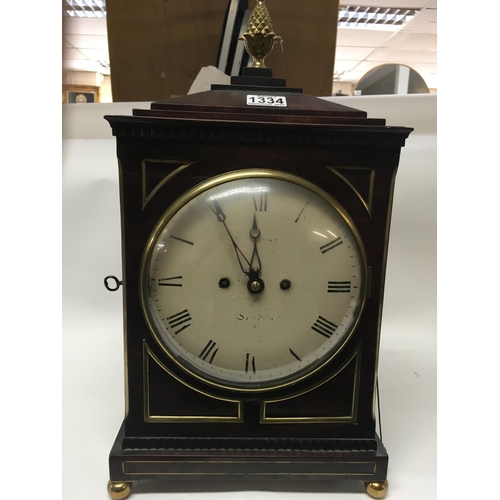 1334 - A Georgian mahogany bracket clock, circular dial with Roman numerals. Maker William Hurst