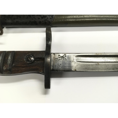 1605 - An American 1917 Remington bayonet with metal capped leather scabbard.