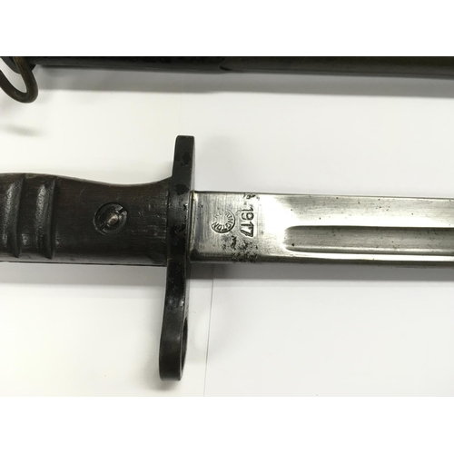 1605 - An American 1917 Remington bayonet with metal capped leather scabbard.