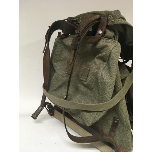 1641 - A military type vintage Rucksack with adjustable leather straps.