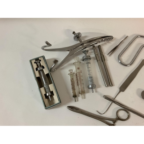 1950 - A collection of medical items, including surgical instruments, vintage syringes x4, and a hip replac... 