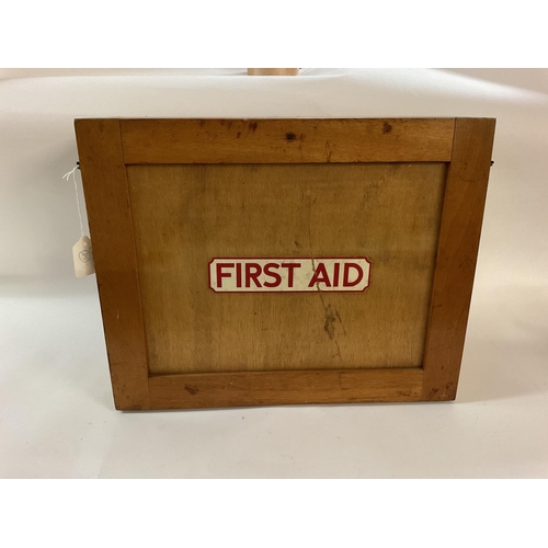 1951 - A vintage first aid cabinet, wooden, with a selection of vintage first aid items, including splint s... 