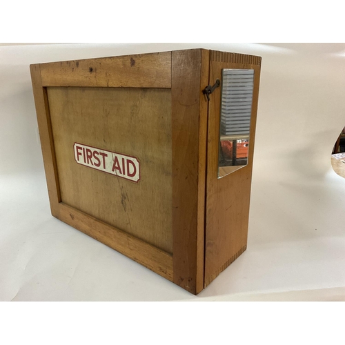 1951 - A vintage first aid cabinet, wooden, with a selection of vintage first aid items, including splint s... 