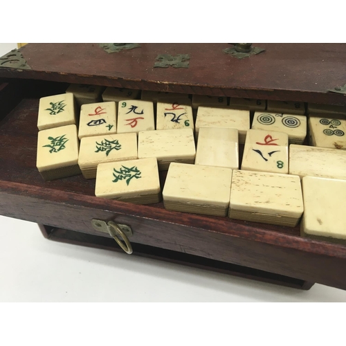 2039 - A bone Mah Jong set fitted in five drawers with book .