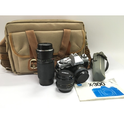 2073 - A Minolta X300 camera, lenses and accessories.