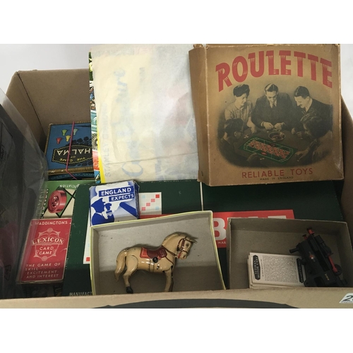 2074 - A box containing vintage games a tinplate clockwork horse and stamp albums and loose stamps. (a lot)