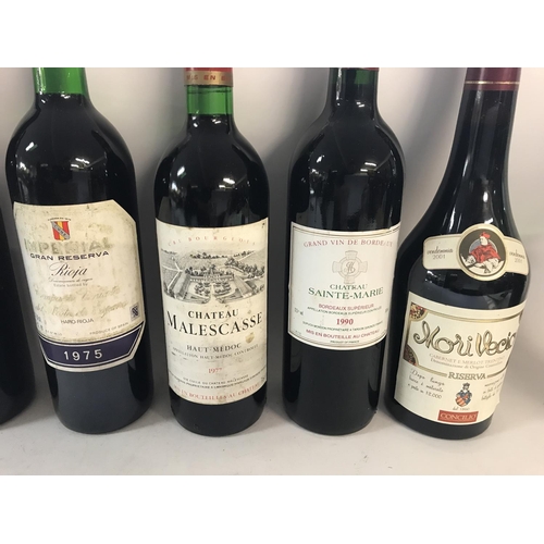 2123 - Collection of various red wines including a bottle of 1977 Chateau Malescasse and a 1990 chateau sai... 