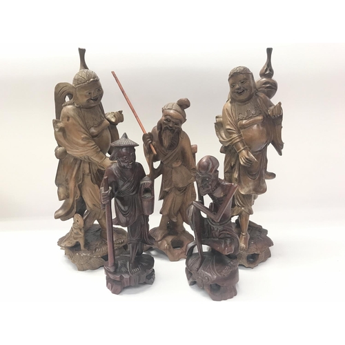 703 - Five carved oriental wooden figures