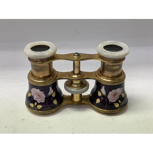 706 - A pair of French enamelled opera glasses with mother of Pearl fittings. ( some unfortunate damage).