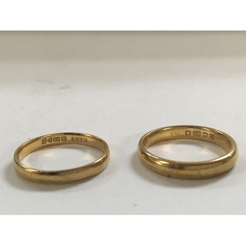 765 - A pair of 22ct wedding rings. Total weight approximately 6g.