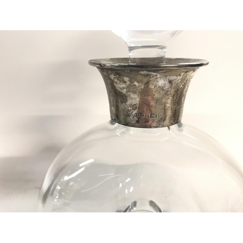 803 - A glass decanter with a Hallmarked silver collar.