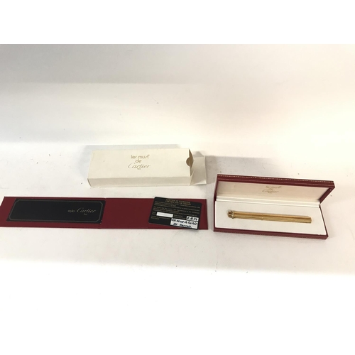 806 - A Cartier gold pen with original certificate of origin and case.