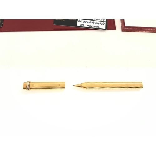 806 - A Cartier gold pen with original certificate of origin and case.