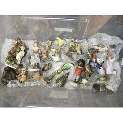 869 - A box containing a collection of ceramic ornaments comprising figures of birds, ladies, posies etc.