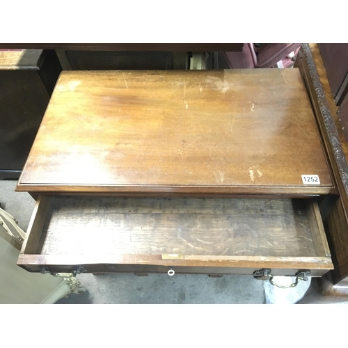 1252 - A mahogany kneehole desk fitted with nine drawers central cupboard door 
On ogee bracket feet . 76 c... 