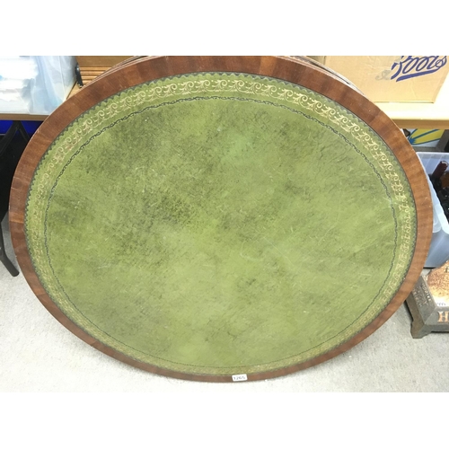 1265 - A Mahogany office drum table the circular top with green leather inset above open section on a turne... 