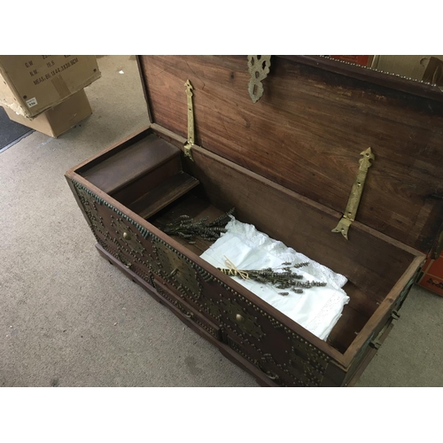 1390 - A Mahogany trunk with applied brass embellishments the trunk with a hinged top above three drawers.