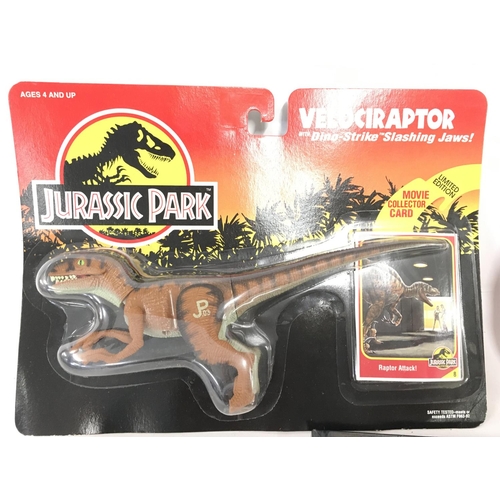 57 - 2 Carded Jurassic Park Figures and a sealed Annual. Including A Velociraptor and a Dimetrodon.