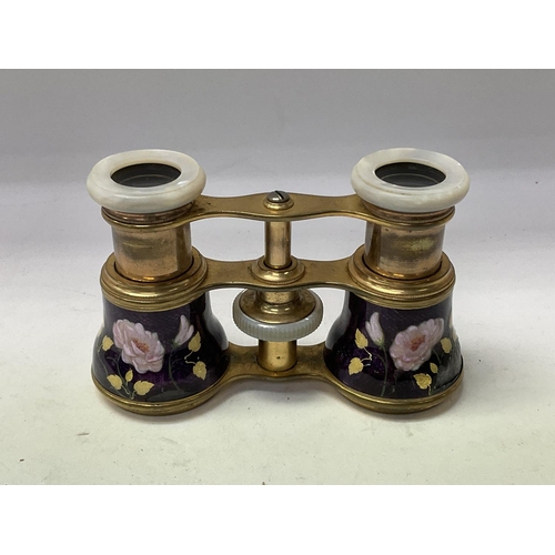 720 - A pair of French enamelled opera glasses with mother of Pearl fittings. ( some unfortunate damage).