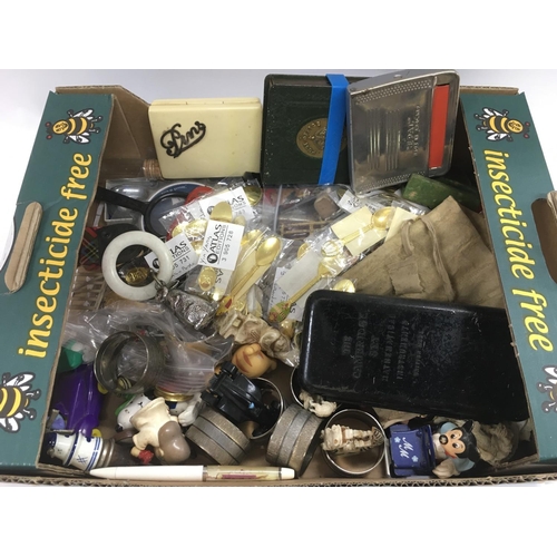 744 - A box of various items including a vintage teething ring, collectable spoons, napkin rings etc.