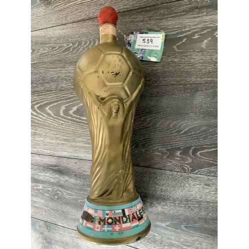 539 - World Cup Trophy Italy 1990 3 Litre Wine: Gold in the shape of the World Cup with flags of participa... 