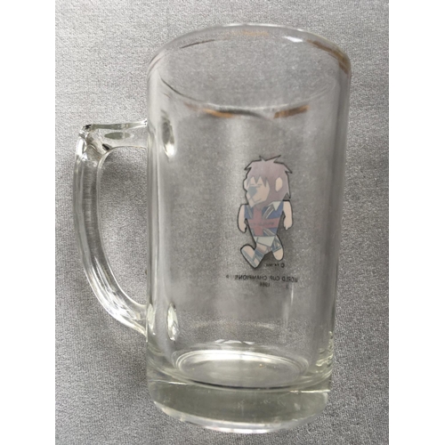 73 - 1966 World Cup Willie Beer Glass: Small glass has handle and features WC Willie with the words World... 