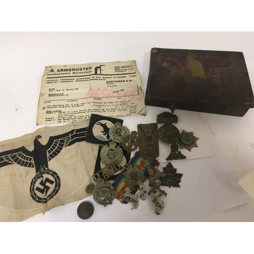 2103 - A German Third Reich cloth badge and a collection of British military cap badges including First Wor... 