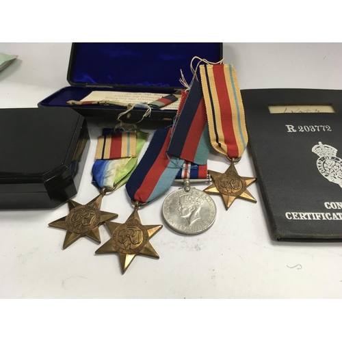2107 - A group of Second World War medals and certificate of discharge.