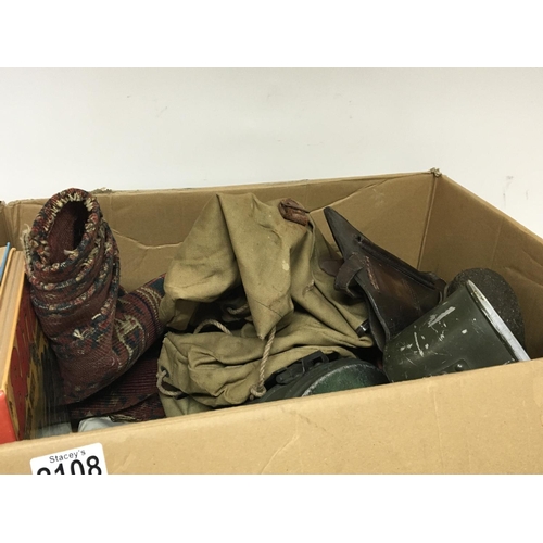 2108 - A box containing military items and other oddments a leather pistol case tins bags and vintage books... 