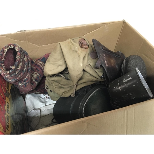 2108 - A box containing military items and other oddments a leather pistol case tins bags and vintage books... 
