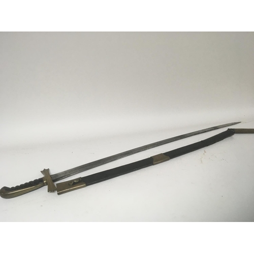 2134 - A sword with with a brass cross guard slightly curved steel blade the leather scabbard with brass mo... 