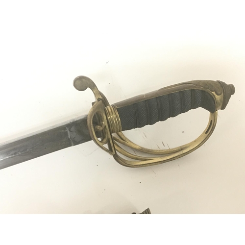 2150 - A Victorian brass field officers sword the decorative guard with Victorian cypher and hinge edge eng... 