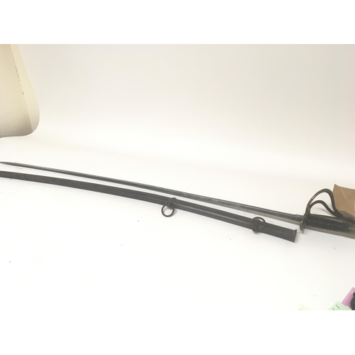 2153 - A 19th century cavalry sword with a brass hilt steel blade and with metal scabbard. Length 108cm.