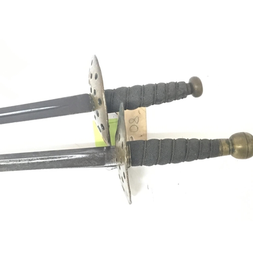 2171 - Two conforming late 19th century swords with round brass guards wired grips and straight tapering st... 