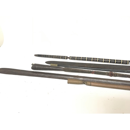 2194 - A collection of tribal spear heads including a lion spear an unusual walking stick and other oddment... 