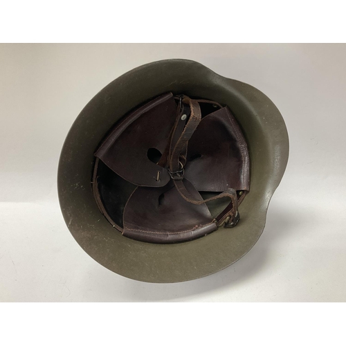 2251 - A Spanish M1942 helmet with leather chin straps and padding.