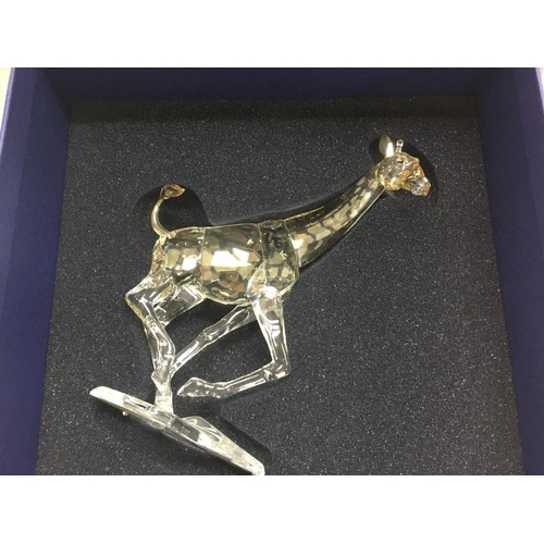 1005 - A boxed Swarovski figure in the form of a Giraffe.