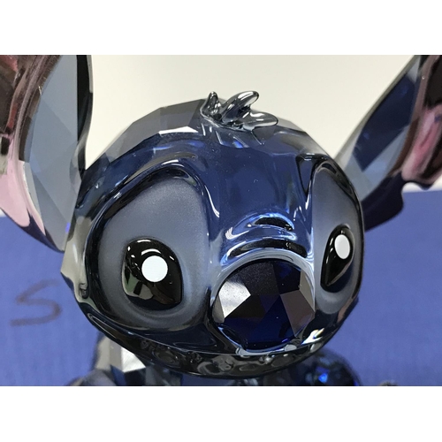 1046 - A Disney Swarovski Crystal figure of Stitch complete with box and name bar. ( 1 finger missing).