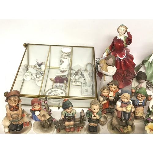 1074 - A collection of Hummel figures, Doulton figures and other ceramics