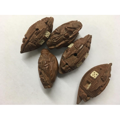 1125 - A collection of  5 oriental carved nuts ,