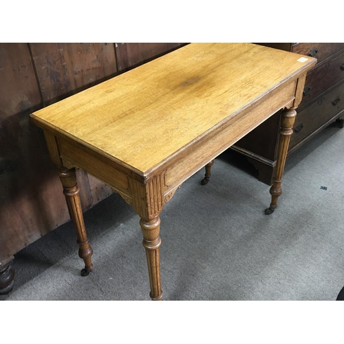 1278 - A carved golden oak late Victorian card table with a hinged top on turned and fluted legs. Length  9... 