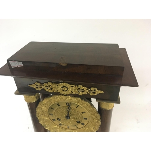 1284 - A French Empire mahogany four pillar clock with a gilded dial and pendulum. For restoration. Height ... 